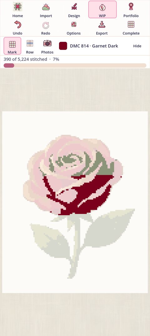 A piece part way through: the dark red thread's finished squares in the rose are shaded green, and the line reads 390 of 5,224 stitched, 7%
